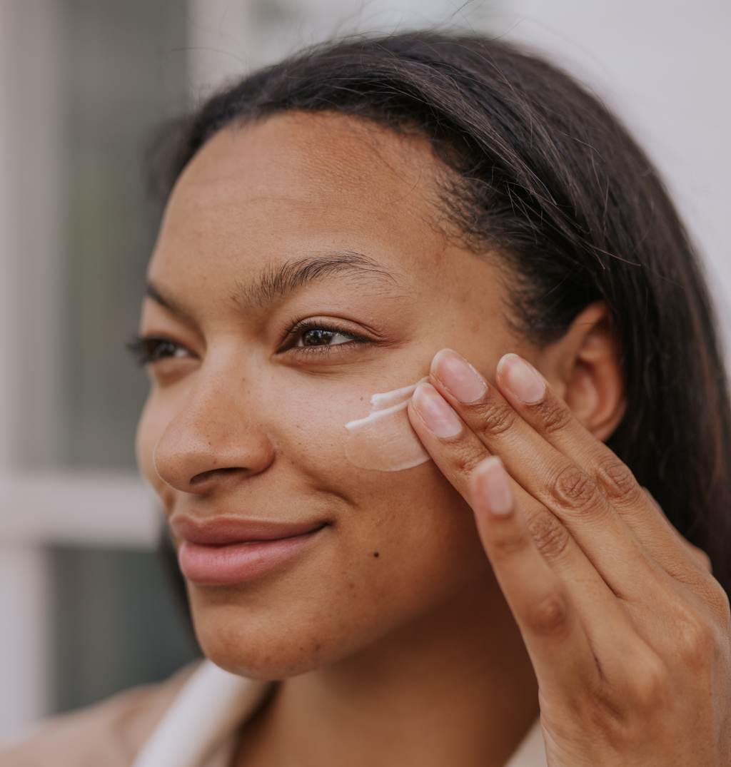 woman applying moisturizer