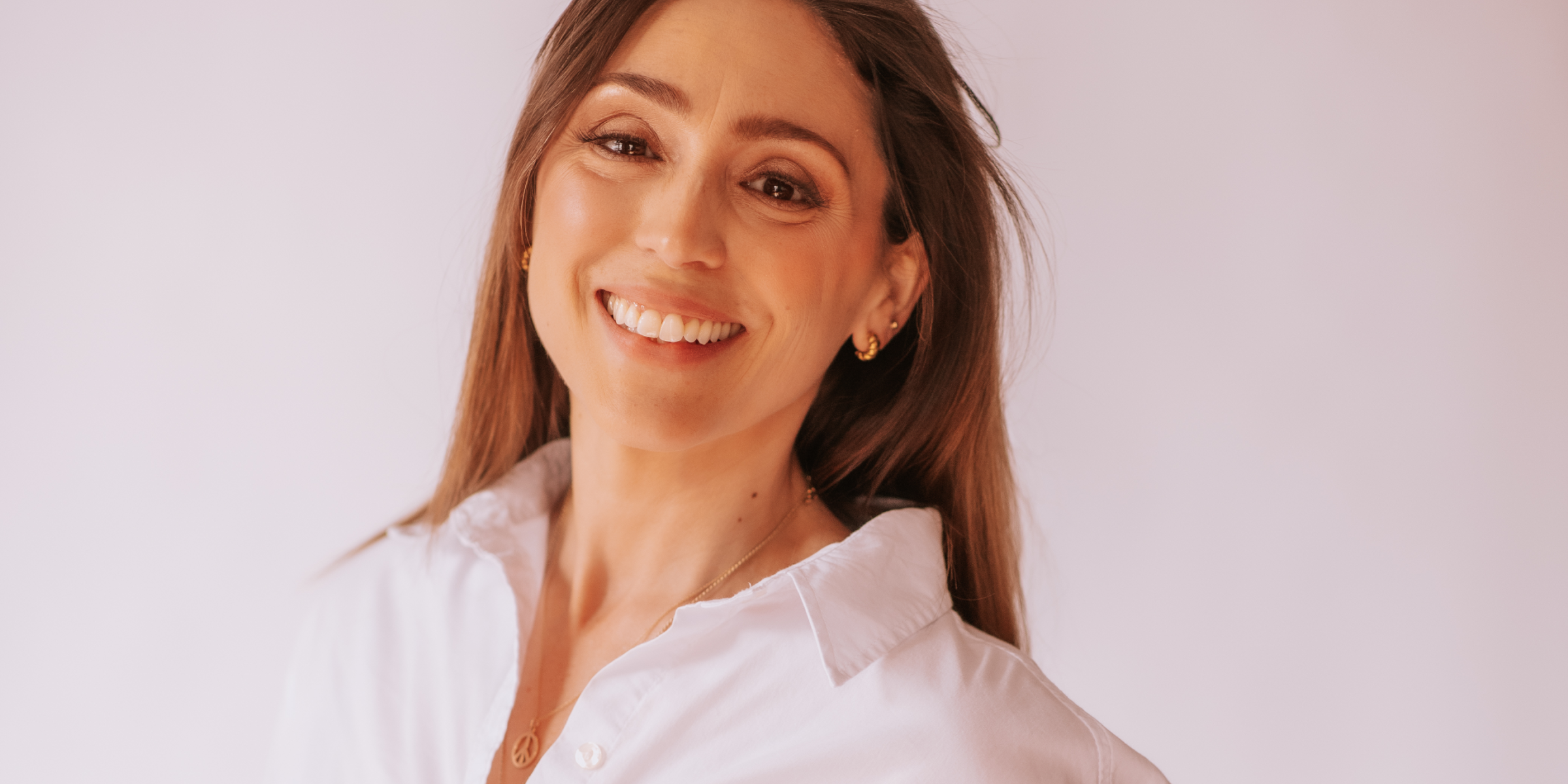 woman smiling in white blouse