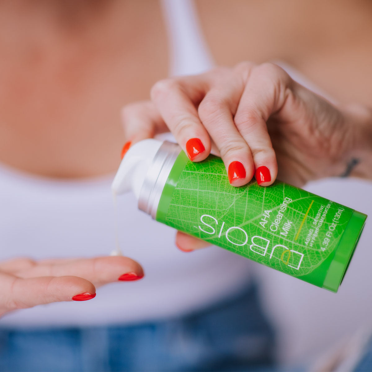 Woman applying AHA Cleansing lotion to hand