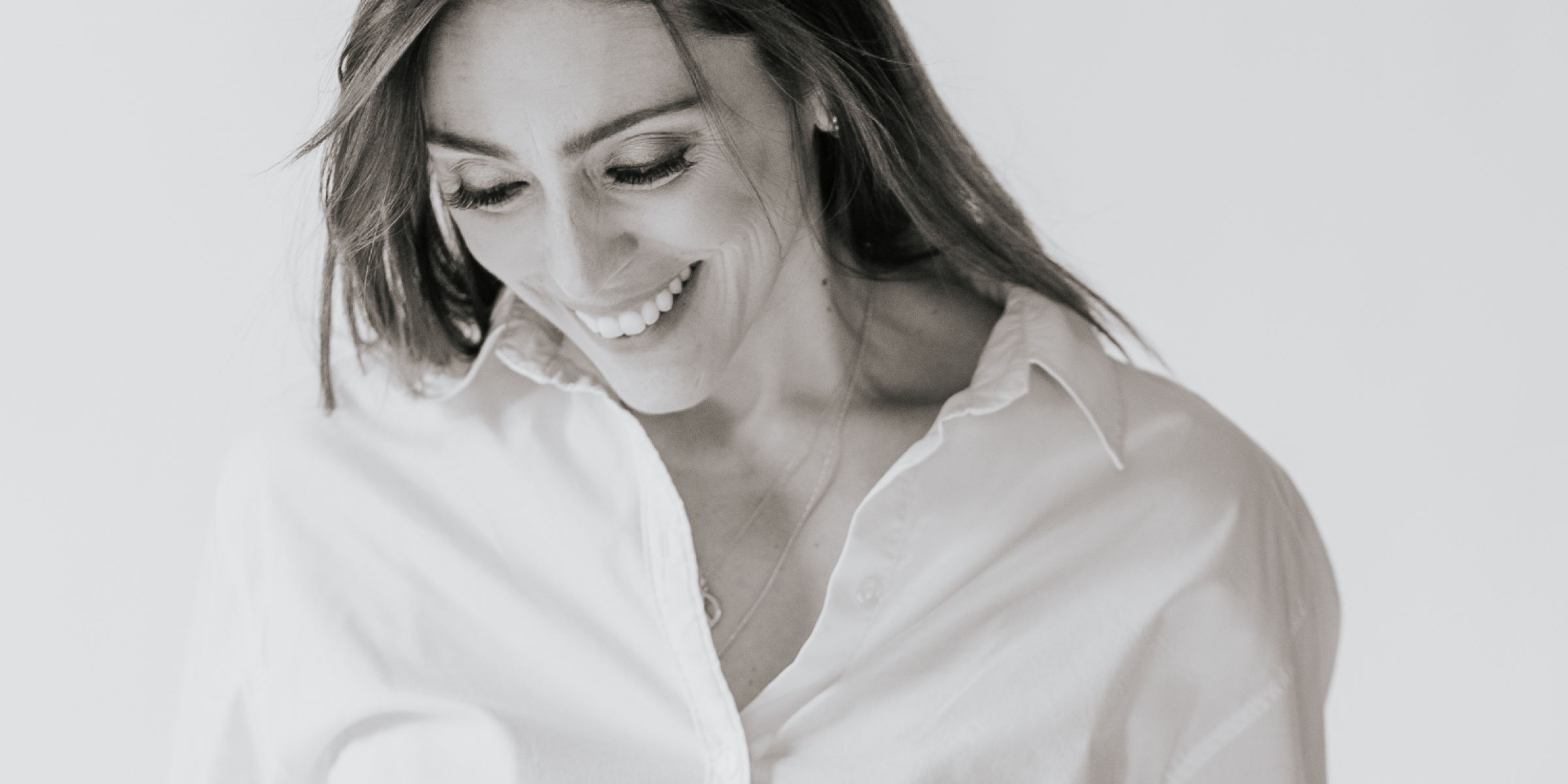 woman smiling in white blouse