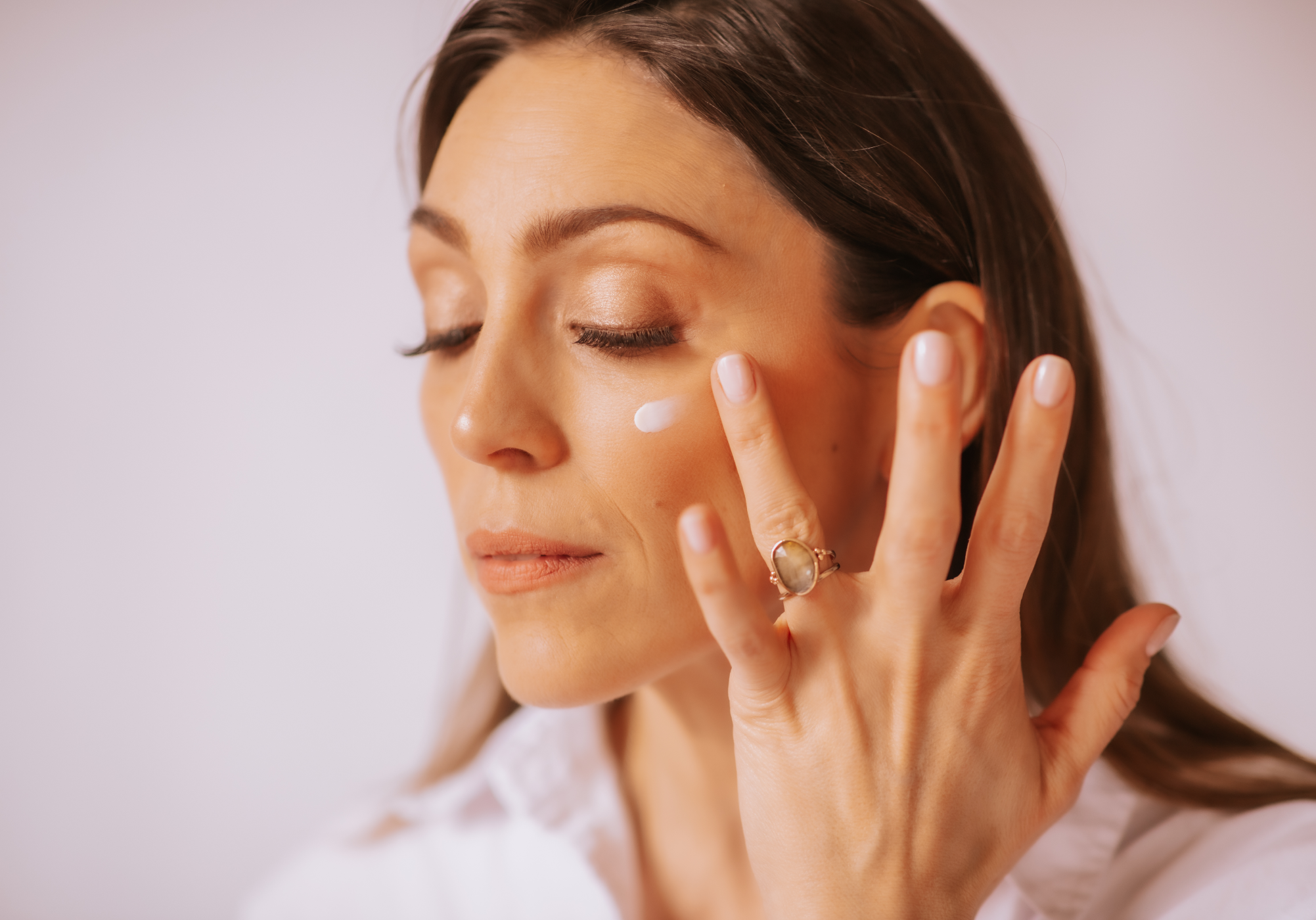 woman applying eye cream