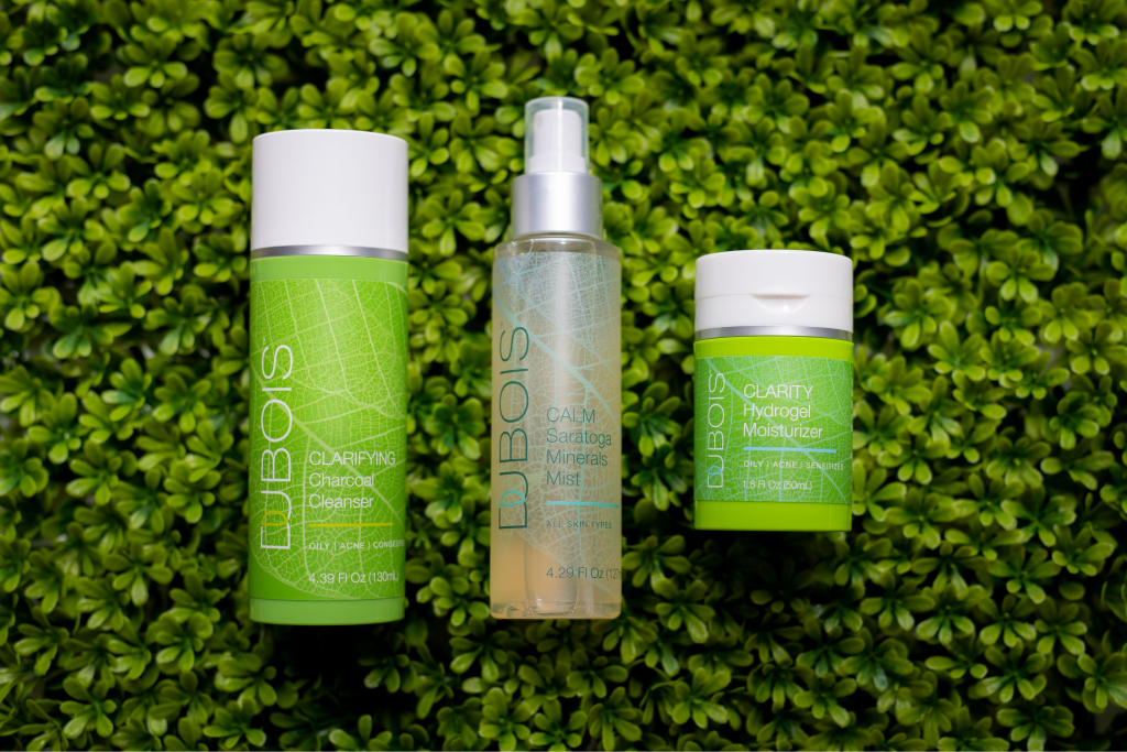dubois beauty products against a green textured background