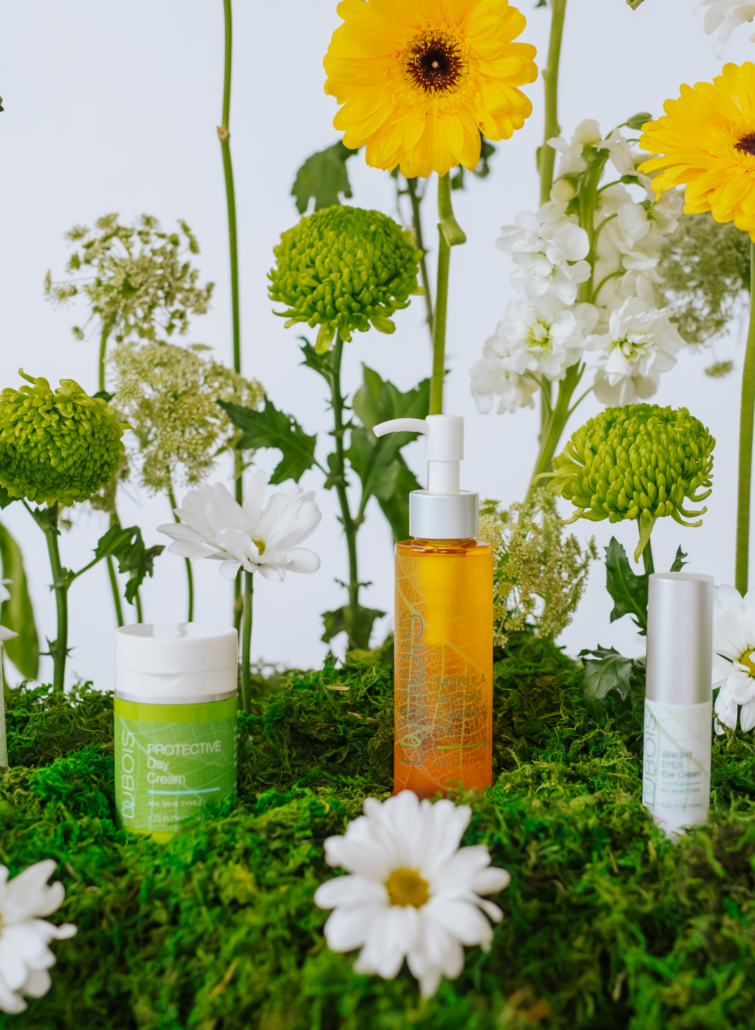 dubois beauty products with flowers and moss