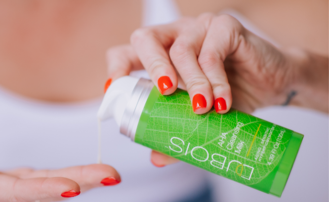 woman dispensing cleanser on fingertips