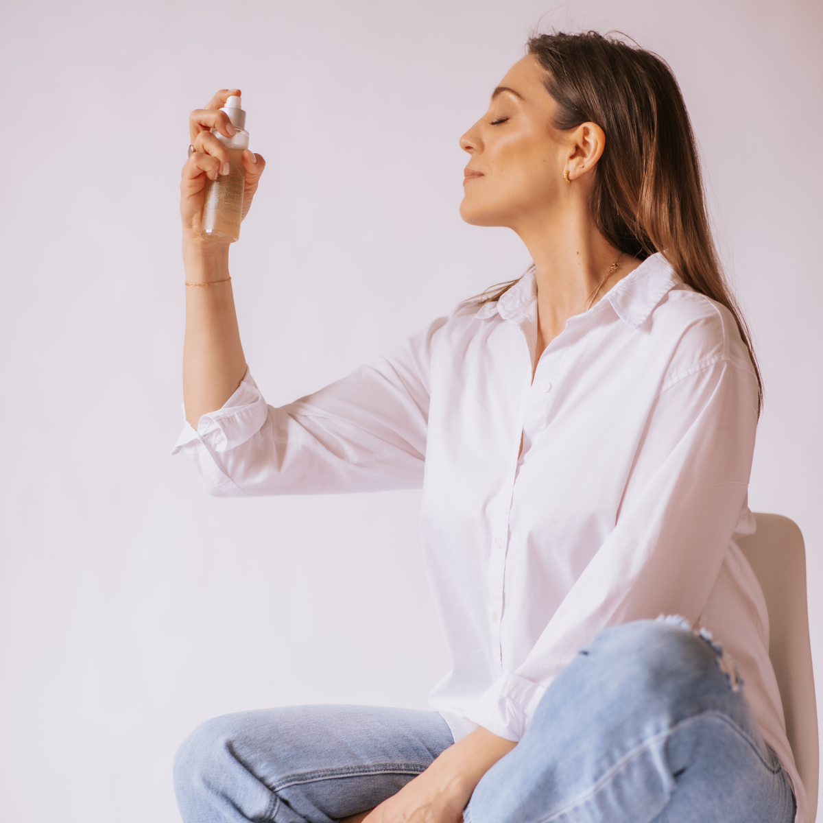woman spraying facial mist
