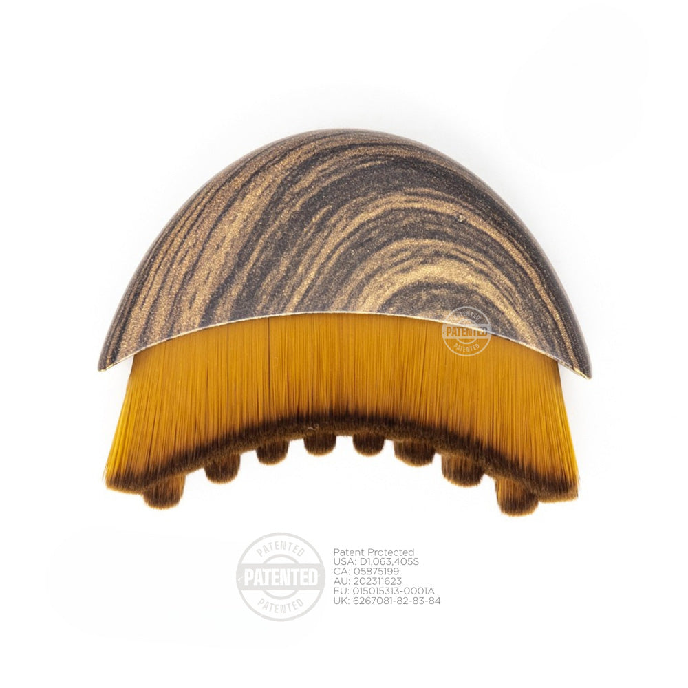Hairbrush with marbled brown and gold handle on a white background