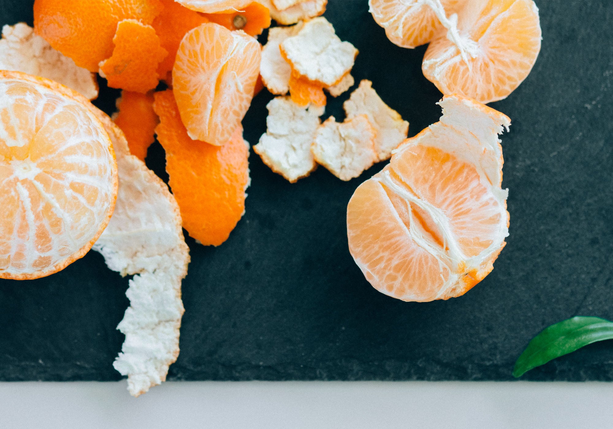peeled oranges on top of a piece of slate